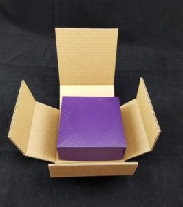 Rigid gift box in book fold style shipper by Salazar Packaging